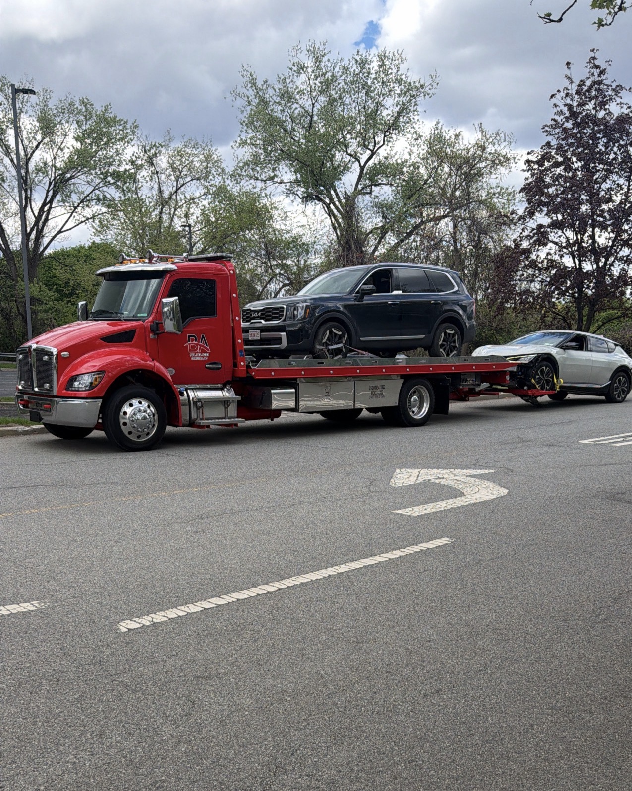 BA Towing red flatbed towing a vehicle